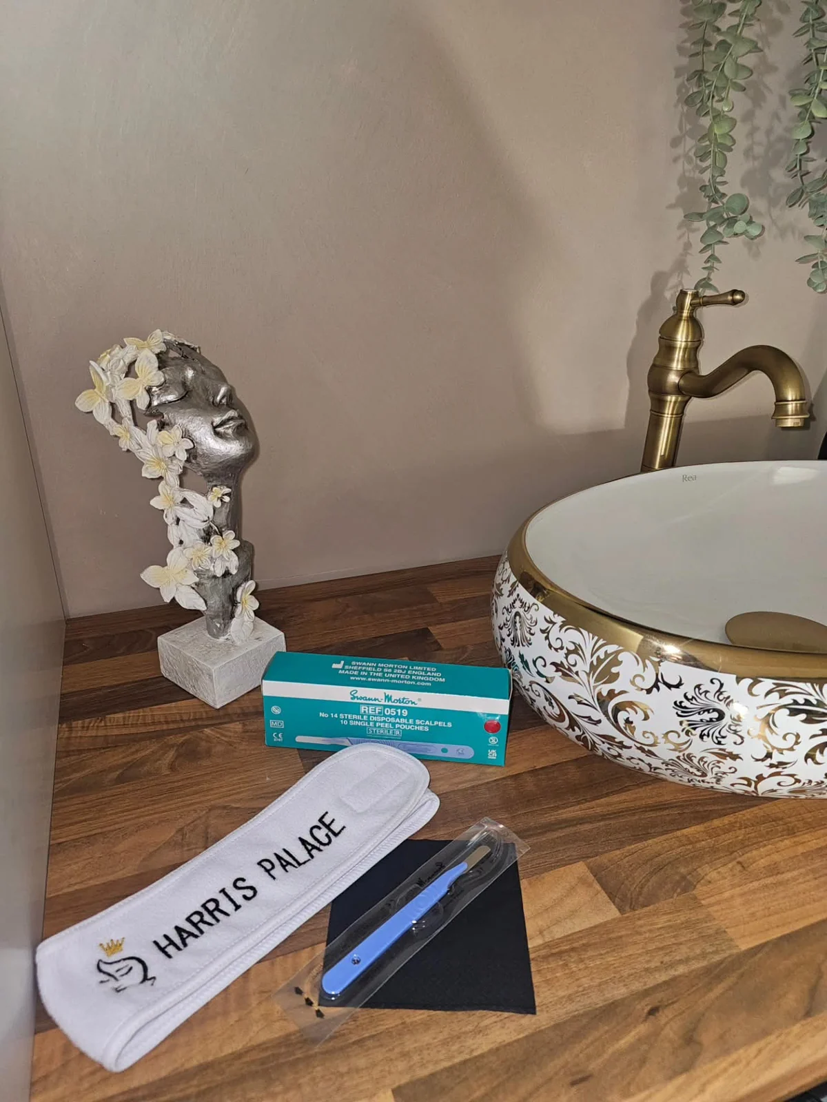 Harris Palace headband and treatment supplies prepared beside the clinic basin
